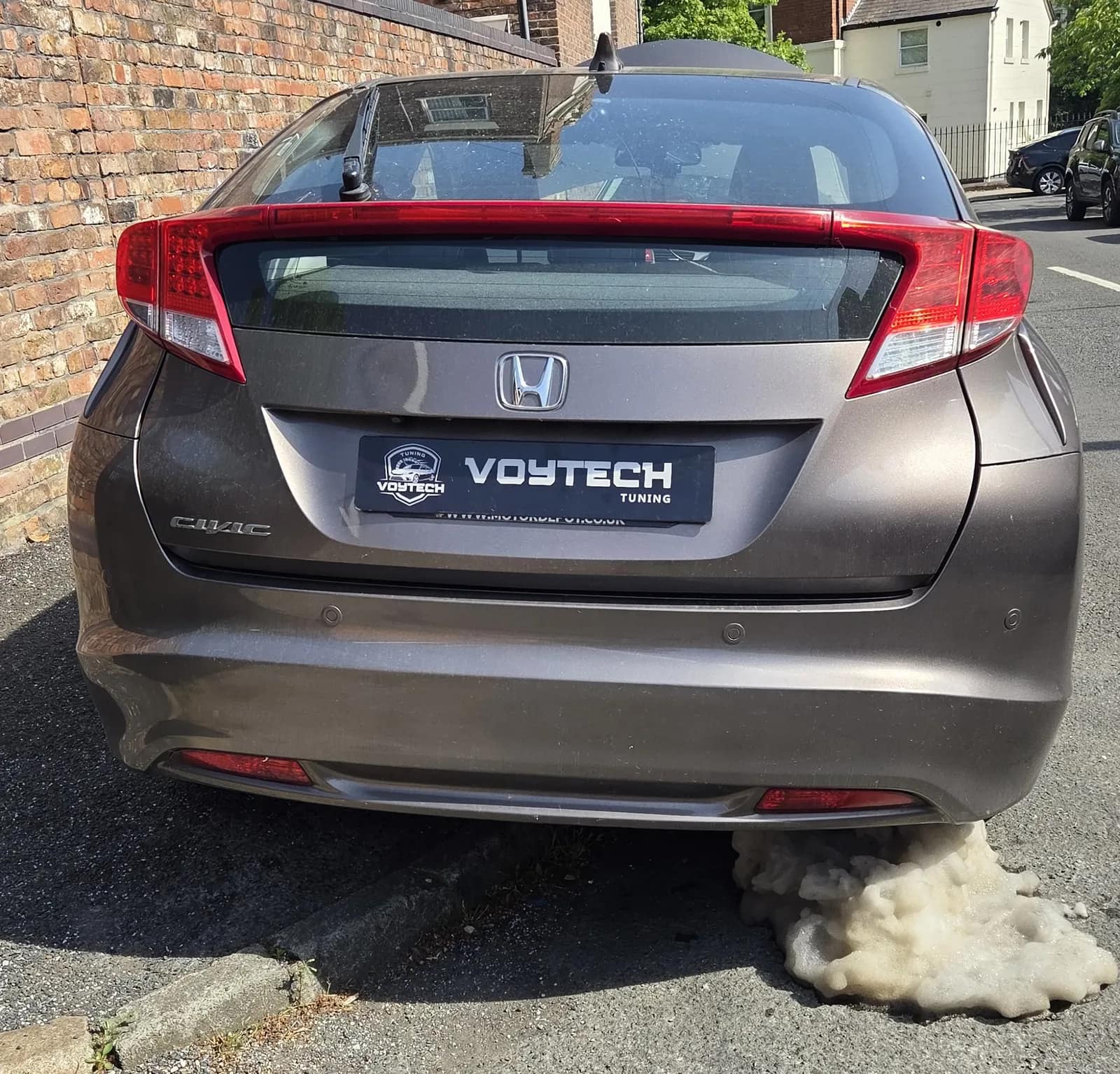 Honda Civic with DPF cleaning foam coming out of the exhaust
