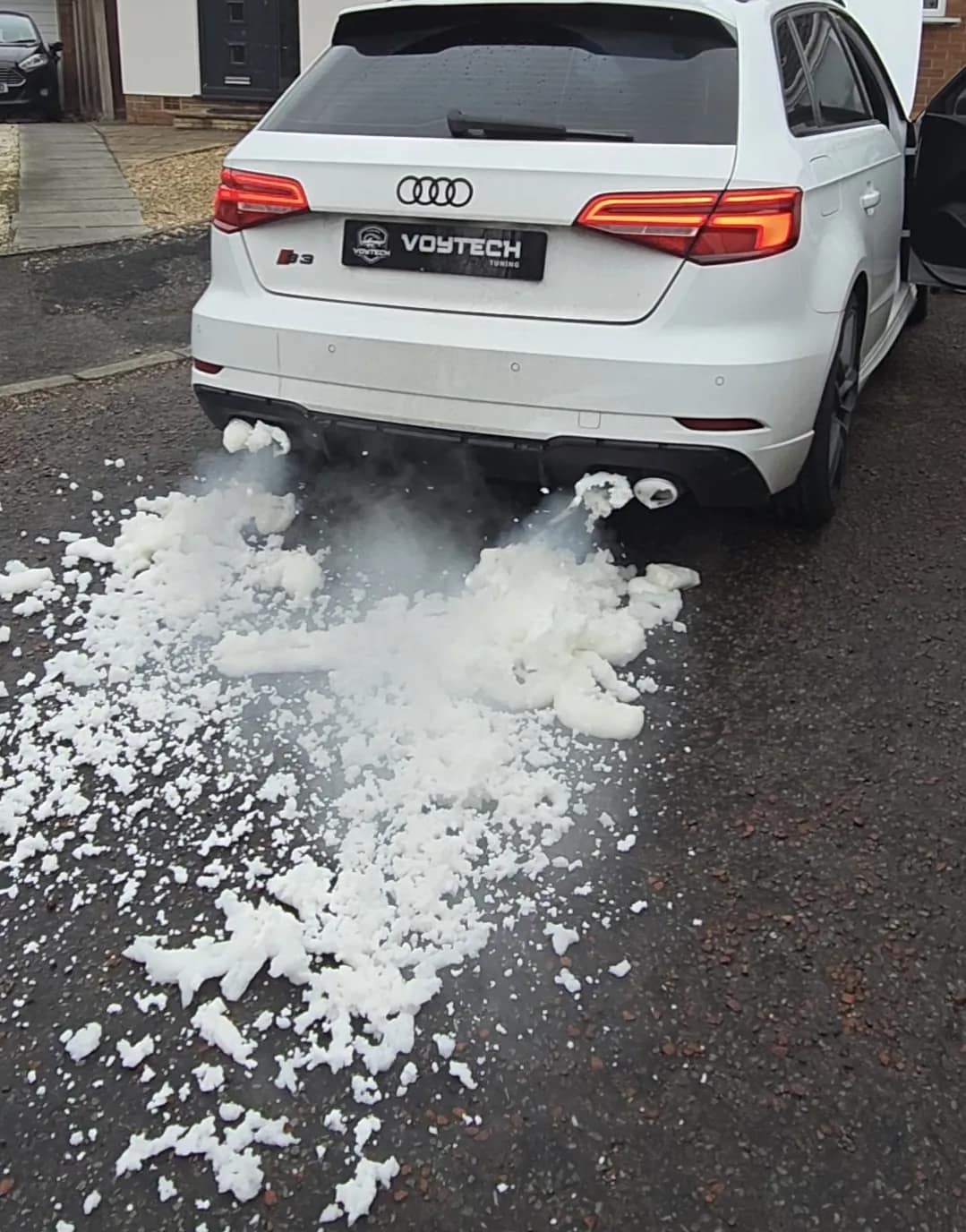 DPF cleaning foam across the drive behind an Audi A3