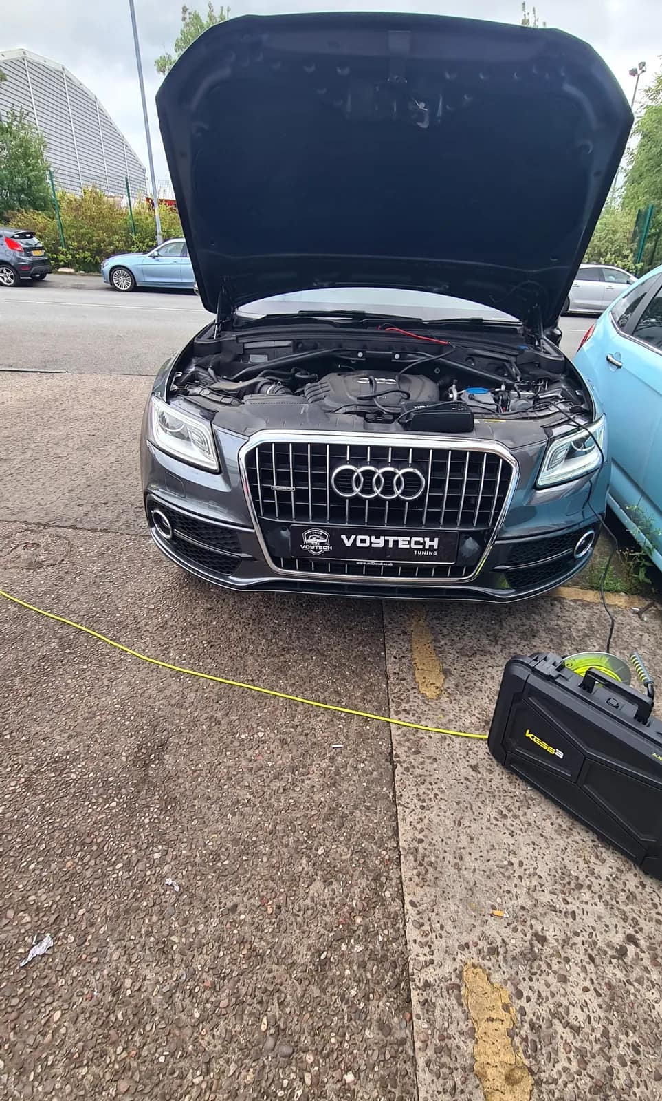 Grey Audi Q5 S line with the bonnet open and the Voytech kit beside it