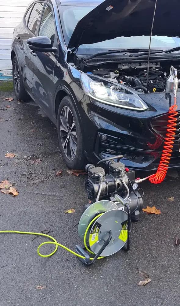 Ford Kuga on a St Helens driveway with the DPF cleaning kit connected under the open bonnet